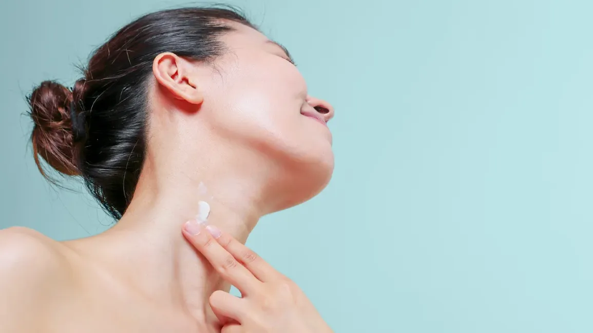 Woman applying moisturizer on neck 1296x728 header.webp